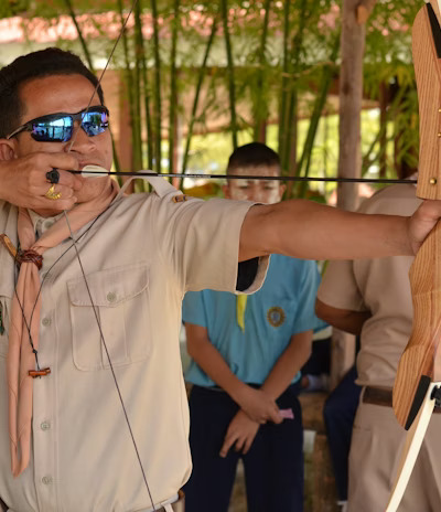 Traditional archer preparing to release an arrow