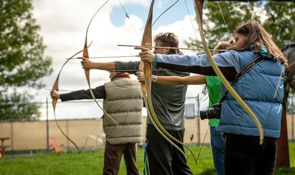 Community participants learning archery outdoors